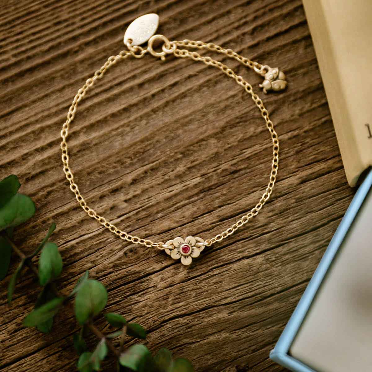 14k gold birthstone bloom bracelet with sweet flower charm and 14k yellow gold lady bug charm