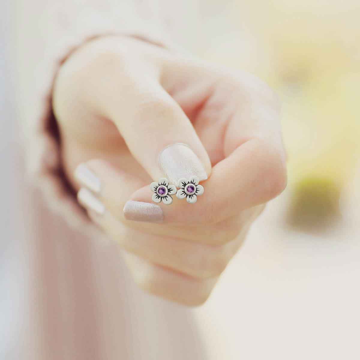 close up of girl wearing sterling silver birthstone bloom stud earrings with personalized birthstone