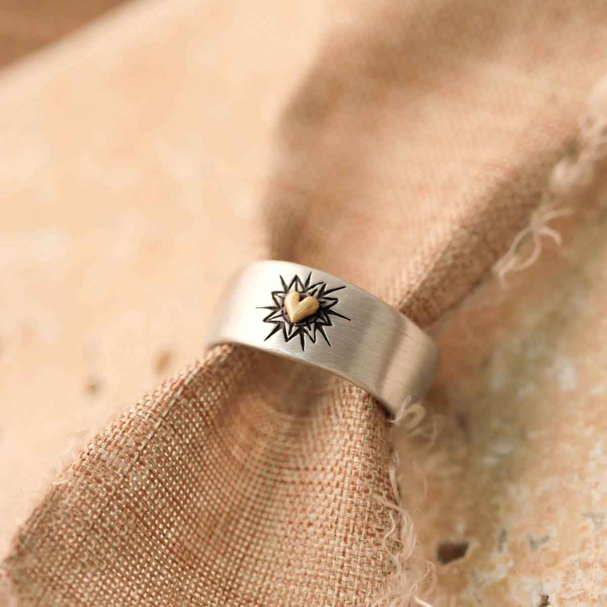 Bursting heart ring hand-molded sterling silver finished with a 10k yellow gold heart and hand-engraved with sunburst design with burlap