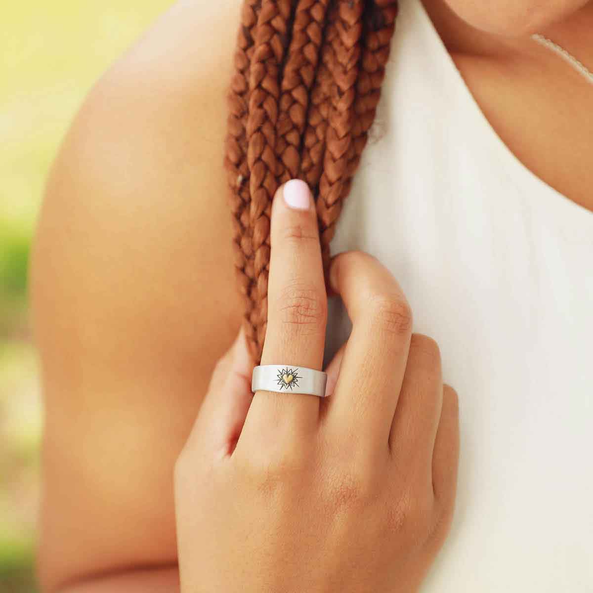 girl wearing sterling silver bursting heart ring