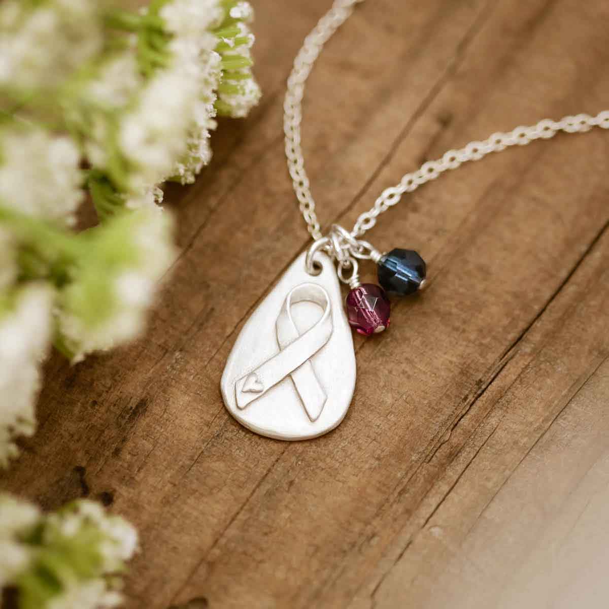 Breast cancer awareness necklace handcrafted in sterling silver with a matte brushed finish