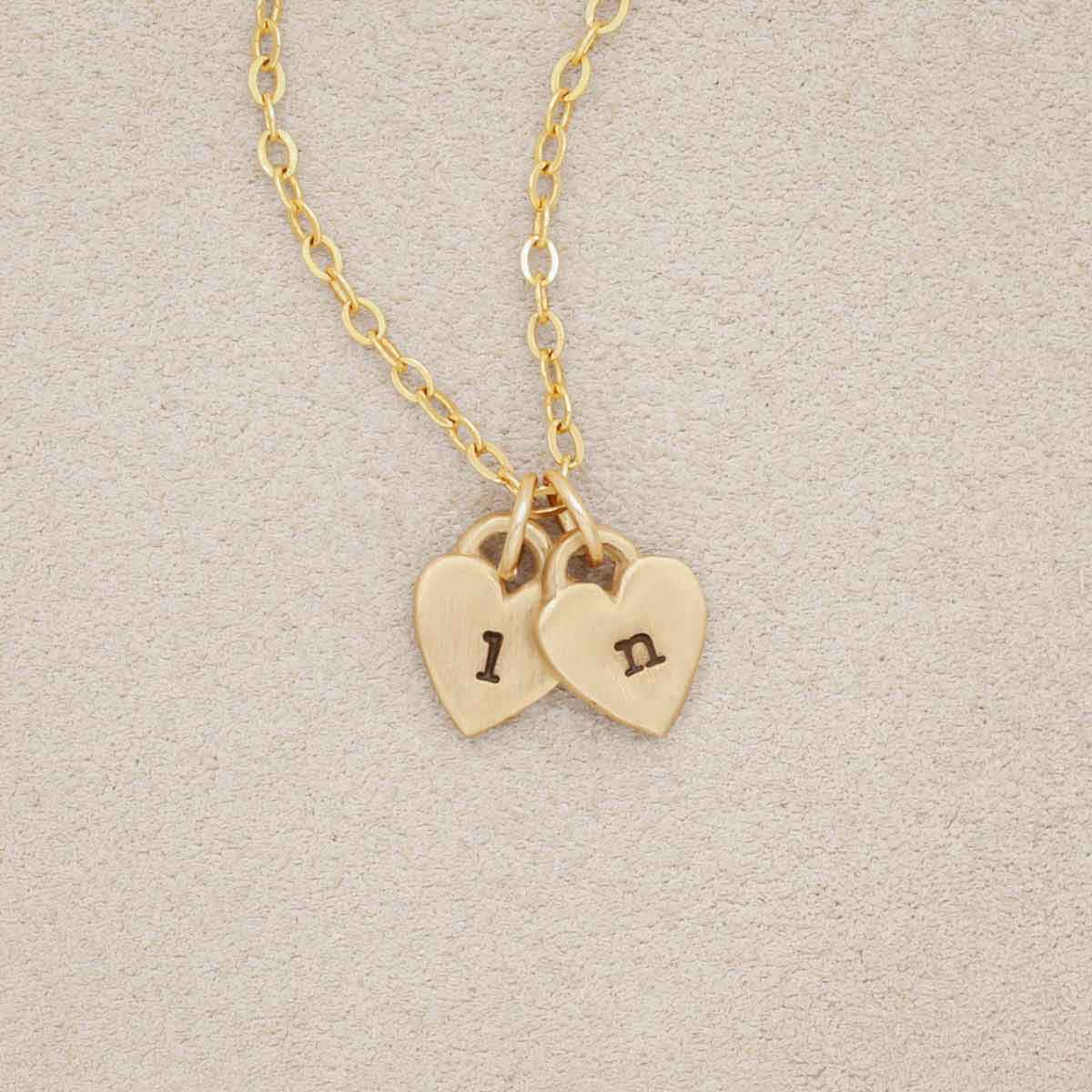 Cherished hearts initials necklace handcrafted in 14k yellow gold including two customizable charms
