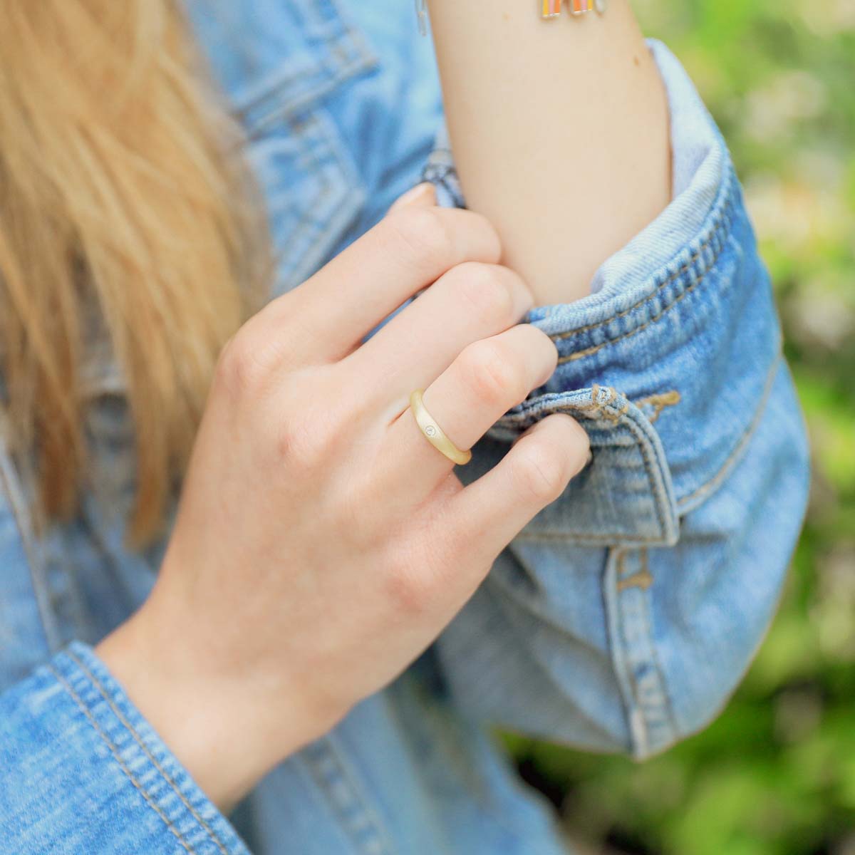 Girl wearing Classic stacking ring hand-molded and cast in 14k yellow gold with a 2mm birthstone or diamond
