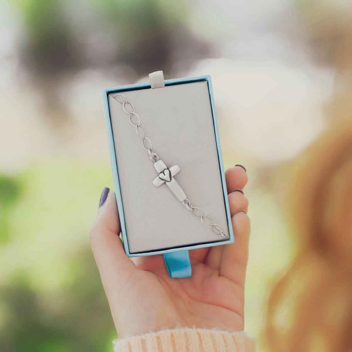 girl wearing sterling silver cross of faith bracelet