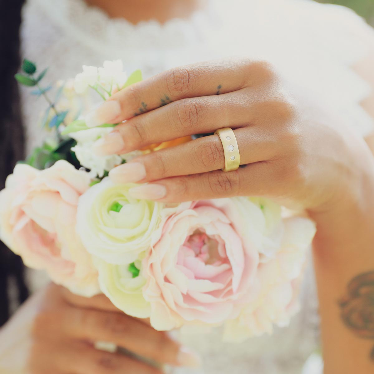 Girl wearing her Faith Hope and Love ring hand-molded in 14k yellow gold set with a 3mm birthstone or diamond and two 2mm stones on the sides