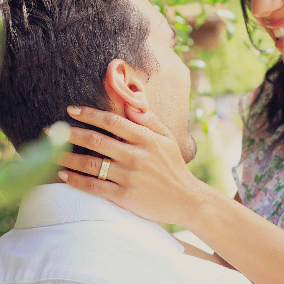 Girl wearing her Faith Hope and Love ring hand-molded in 14k yellow gold set with a 3mm birthstone or diamond and two 2mm stones on the sides with her husband
