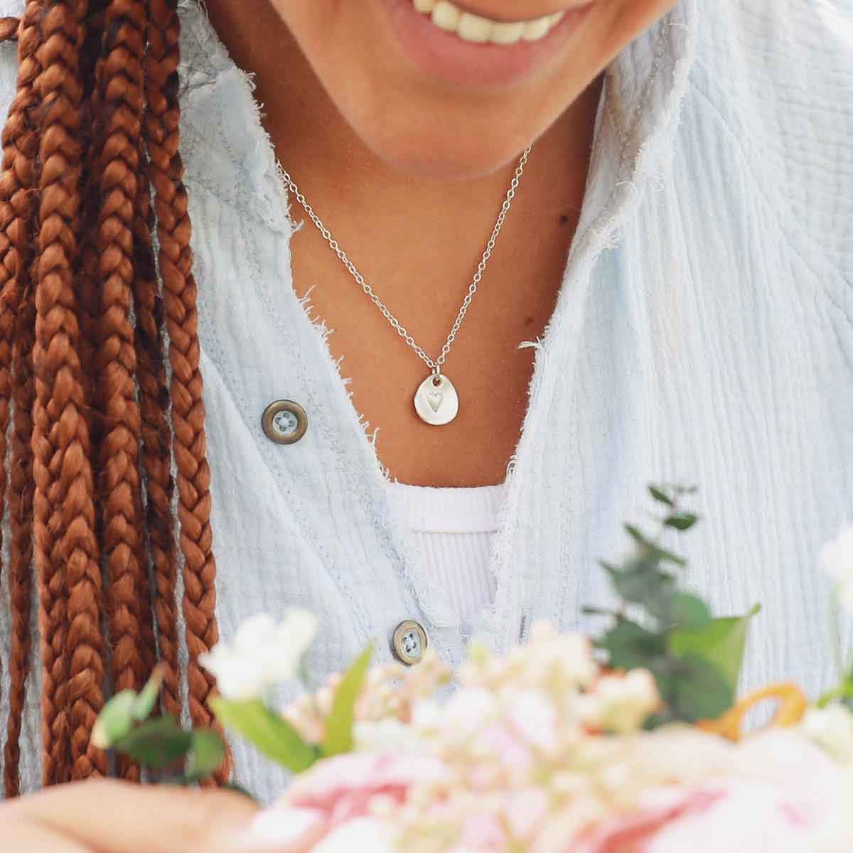 woman wearing a sterling silver full of love necklace