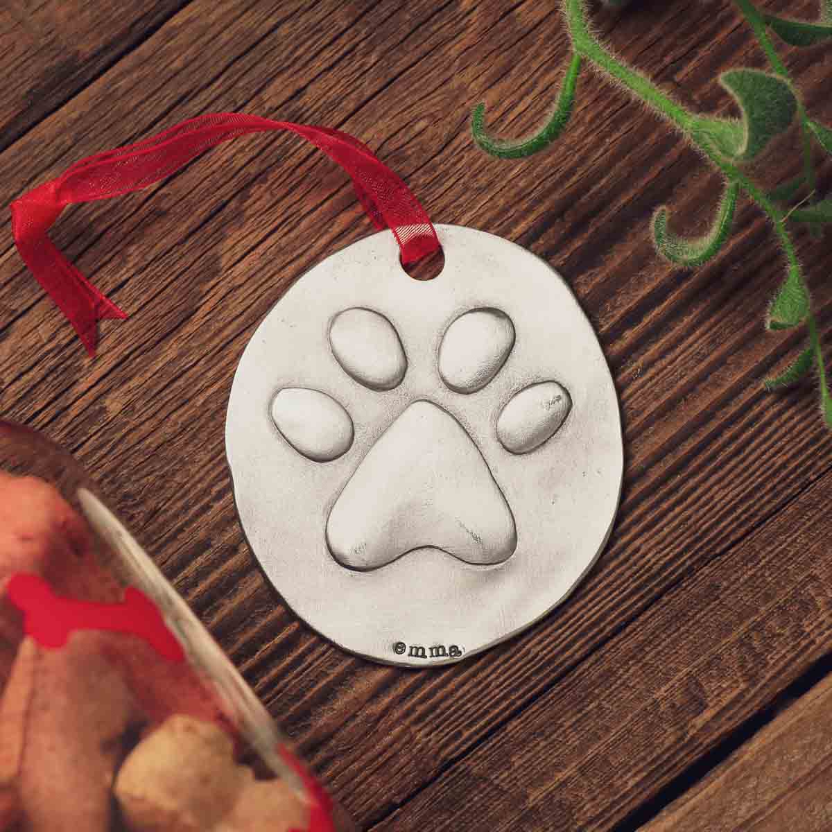 furry footprint ornament hand-molded and cast in fine pewter and personalized with a meaningful name