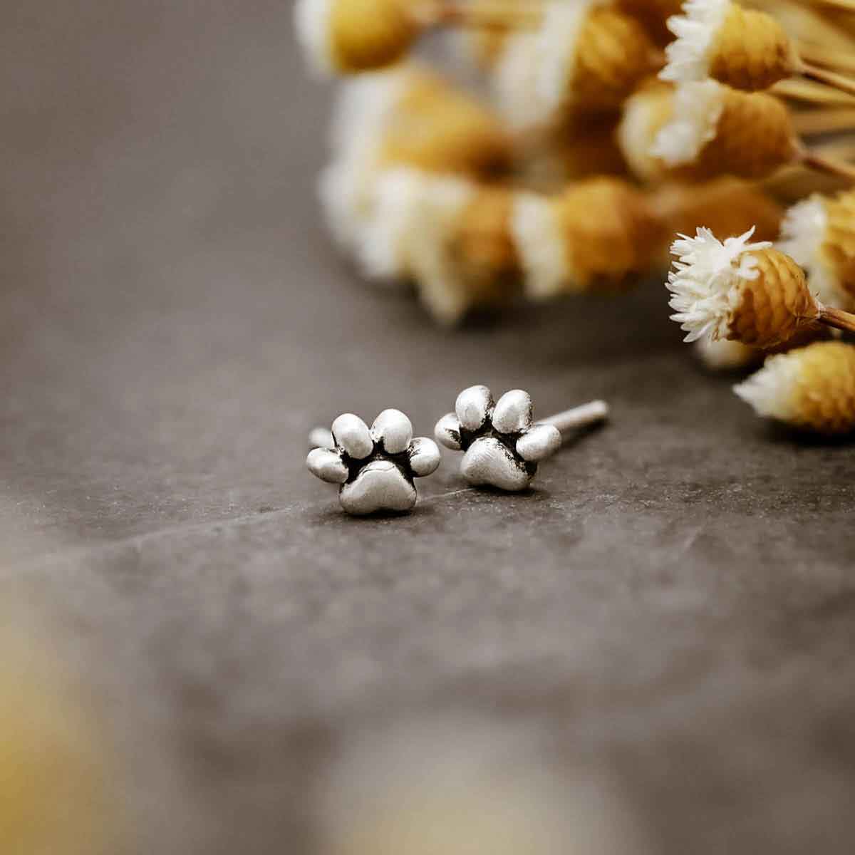 girl wearing Furry Footprint Stud Earrings handcrafted in sterling silver