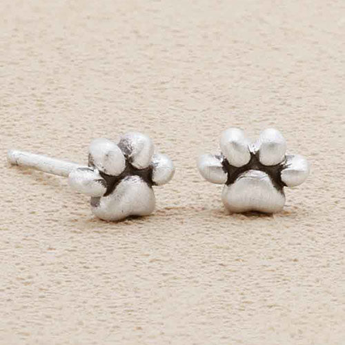 girl wearing Furry Footprint Stud Earrings handcrafted in sterling silver