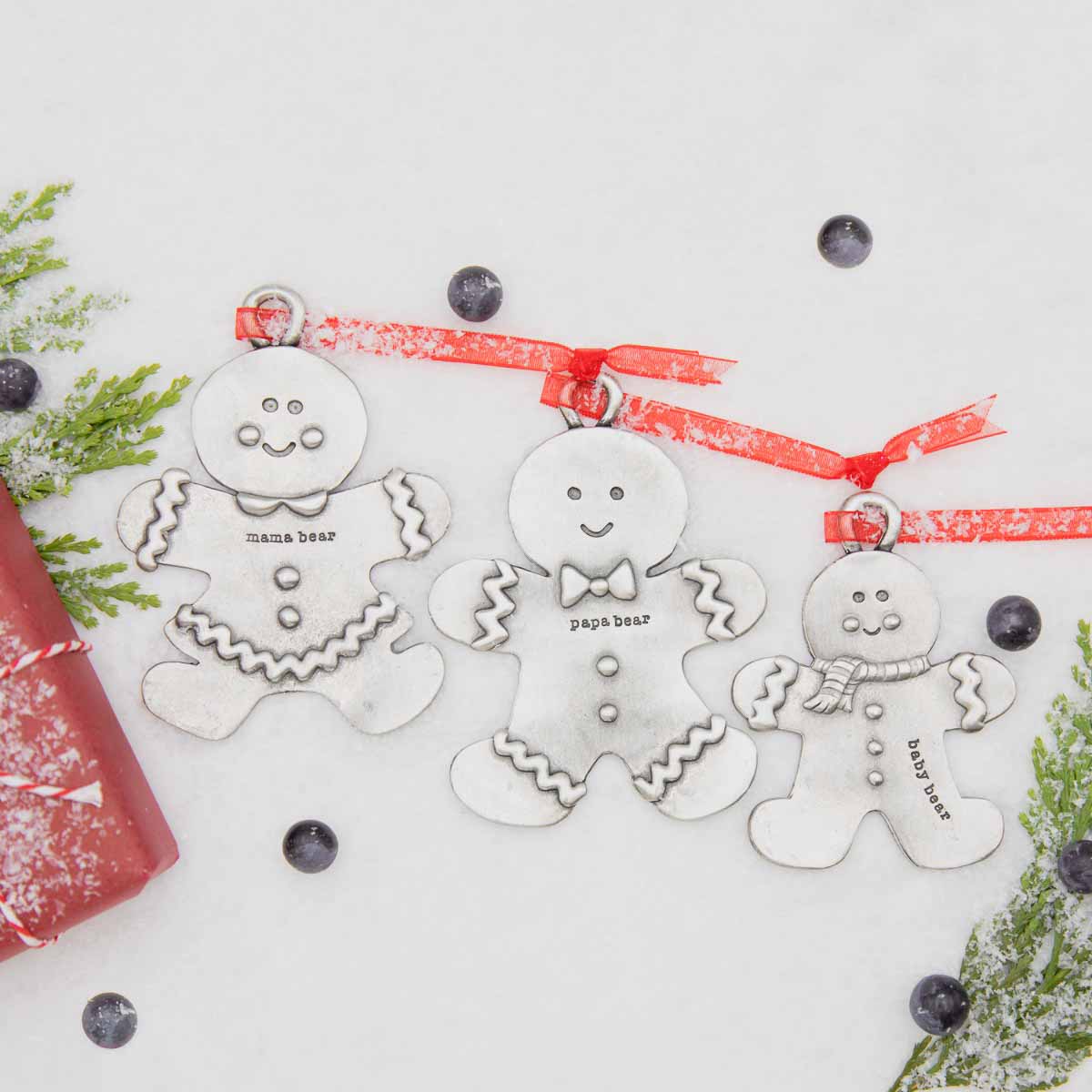 Gingerbread boy ornament hand-molded and cast in fine pewter hung from a sheer red ribbon with a personalized word along with rest of gingerbread family