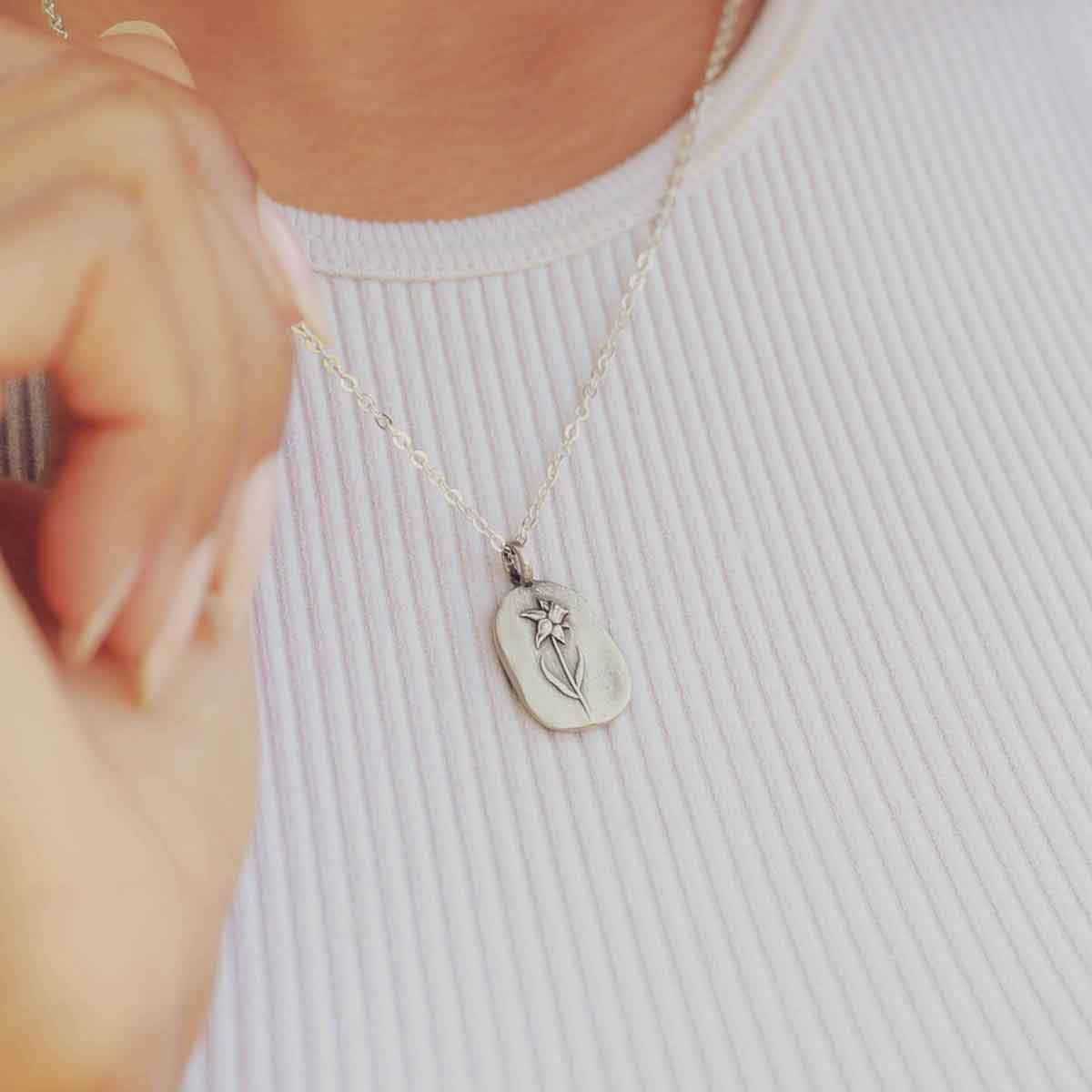 girl wearing a pewter March Birth Flower necklace with an 18" link chain