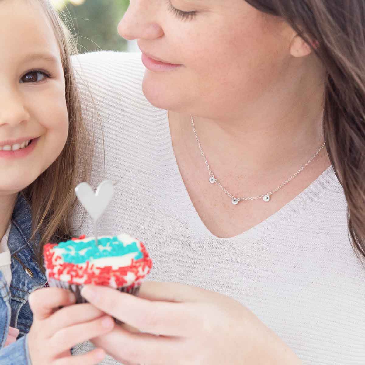 mom wearing sterling silver my darling ones initial necklace personalized with 3 initials