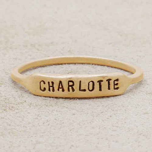 14k yellow gold personalized Nameplate Stacking Ring on a beige background