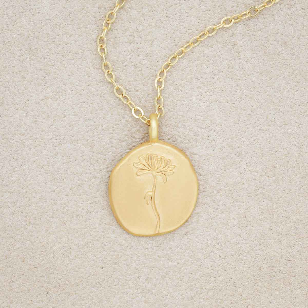 gold plated November birth flower necklace with an 18" gold filled link chain, on beige background