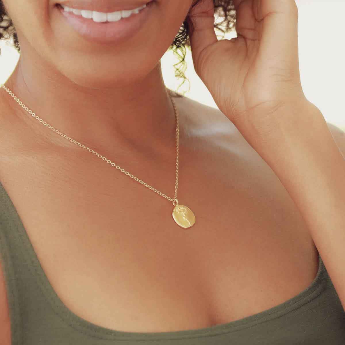 girl wearing a gold plated November birth flower necklace with an 18" gold filled link chain