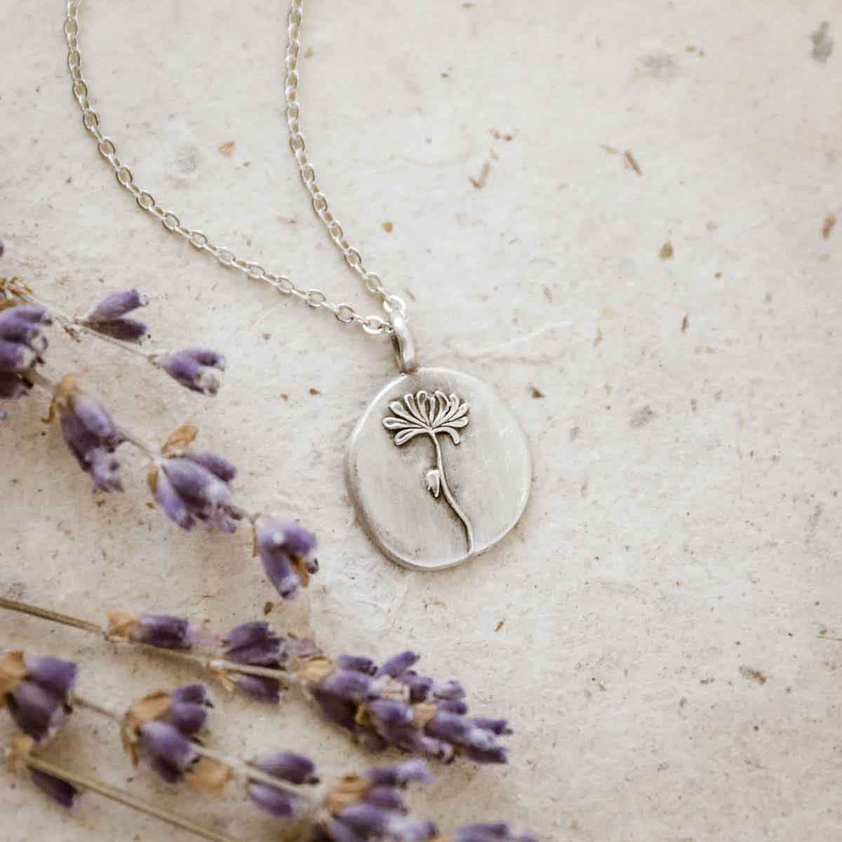 girl wearing a pewter November Birth Flower necklace with 18" link chain