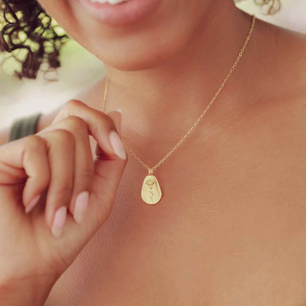 girl wearing a gold plated October birth flower necklace with an 18" gold filled link chain