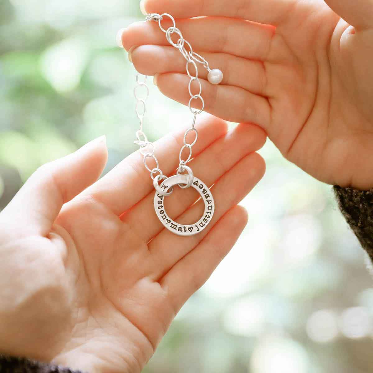 girl holding personalized sterling silver open circle pearl bracelet