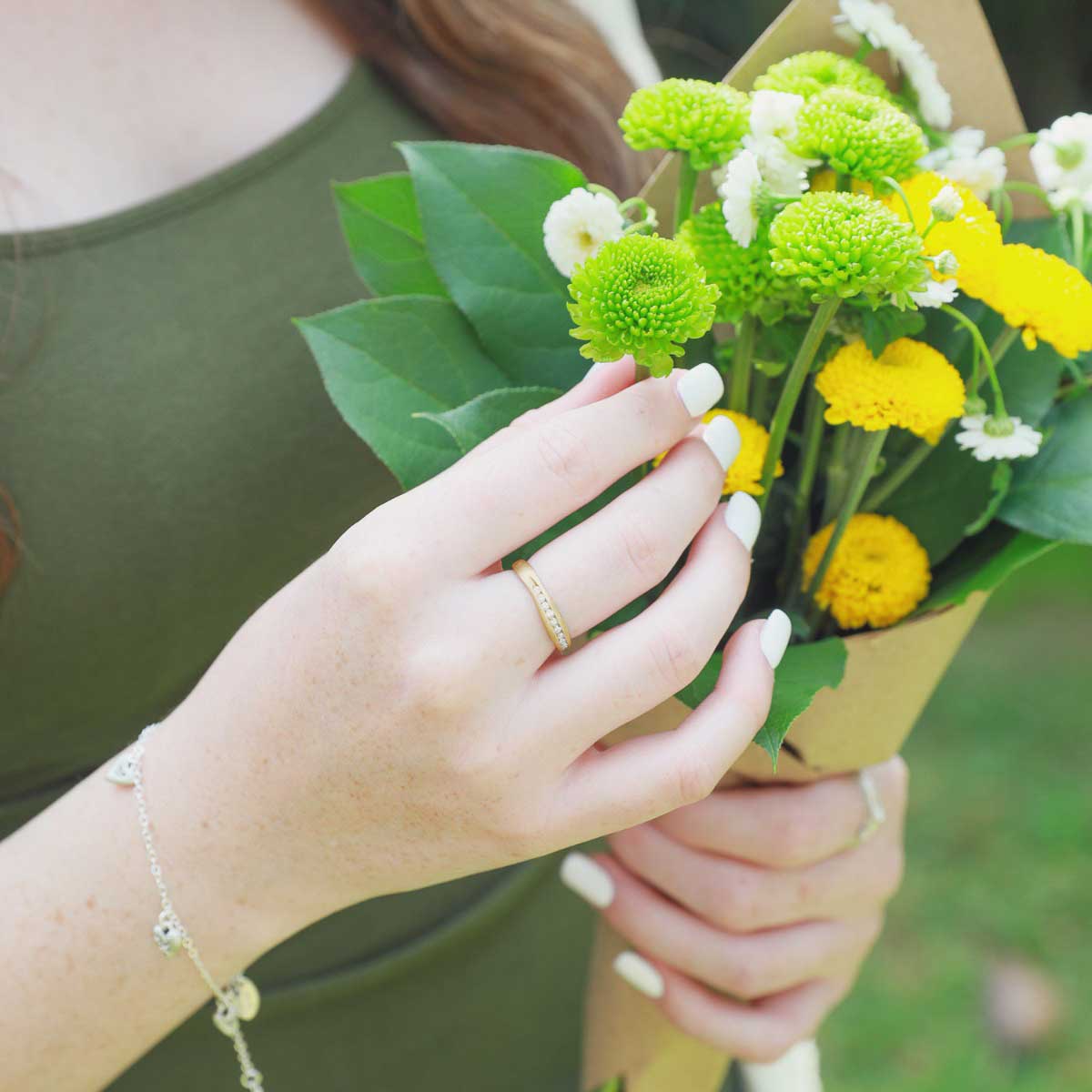 Girl wearing Passage ring handcrafted in 10k yellow gold and display of 1.5mm cubic zirconias