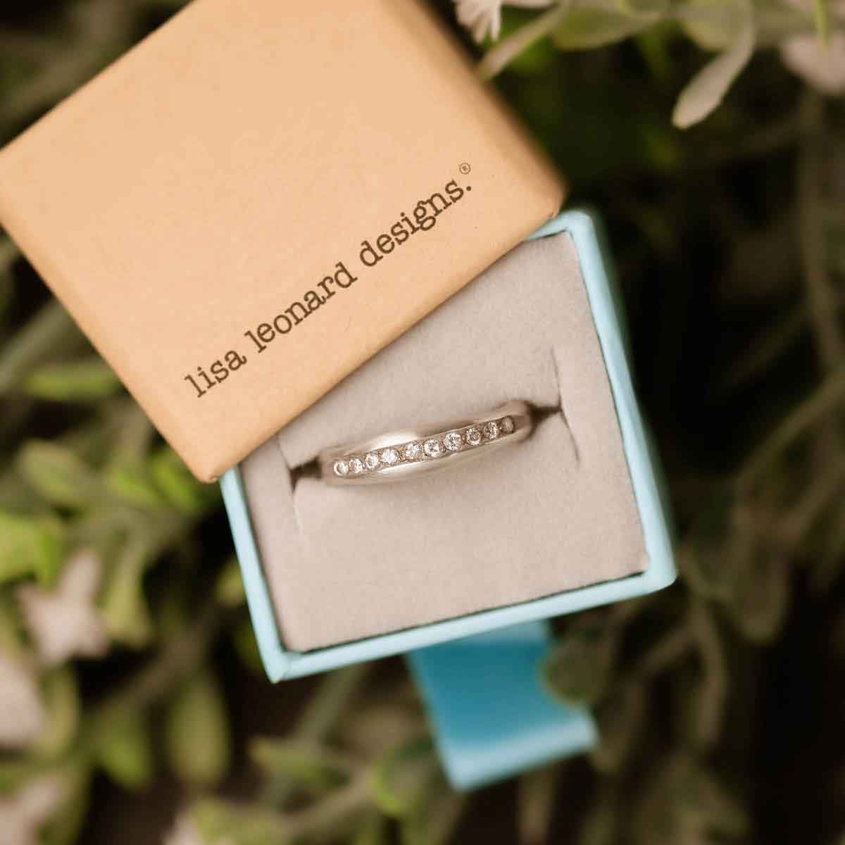 Passage ring handcrafted in sterling silver and display of 1.5mm cubic zirconias in original packaging