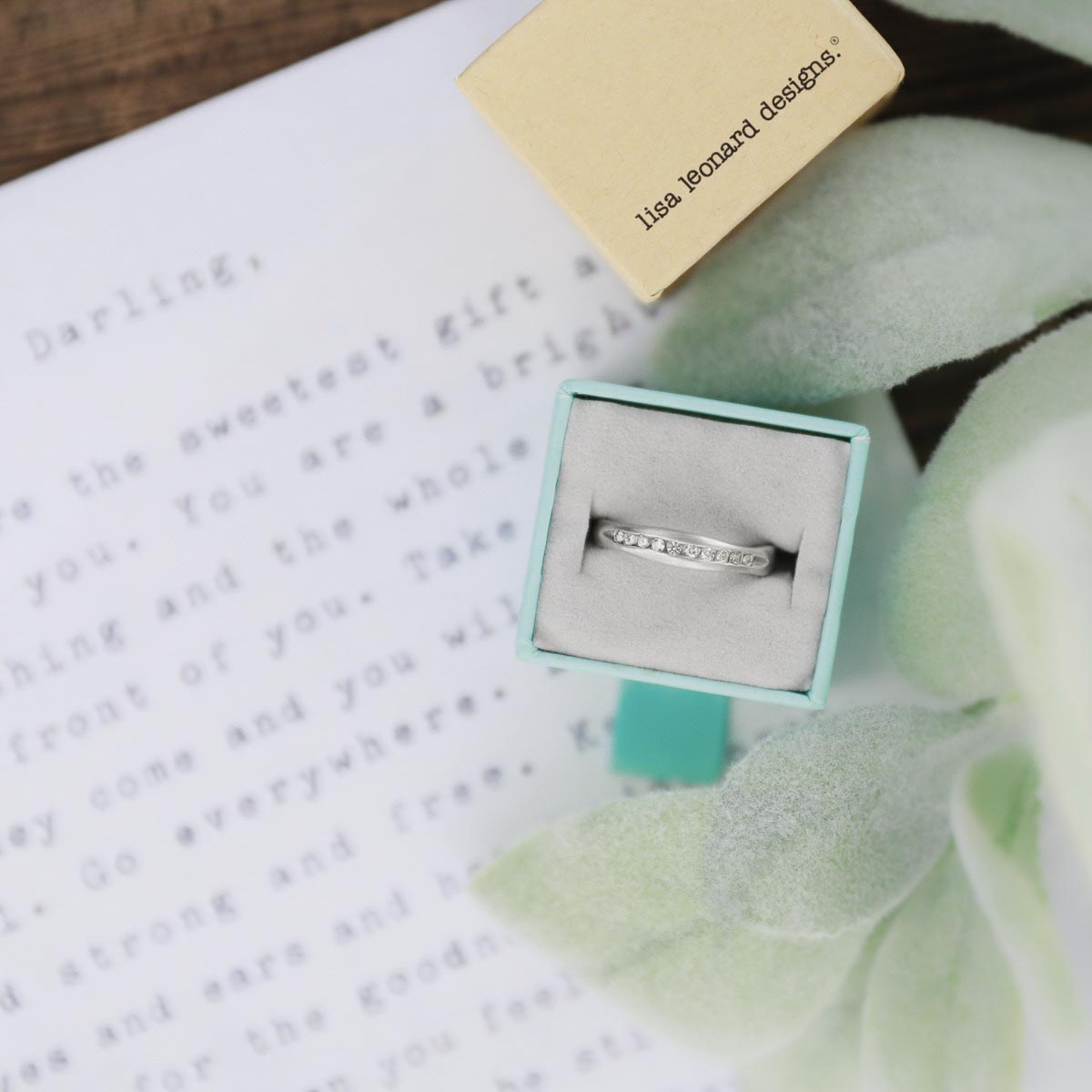 Passage ring handcrafted in sterling silver and display of 1.5mm cubic zirconias in original packaging