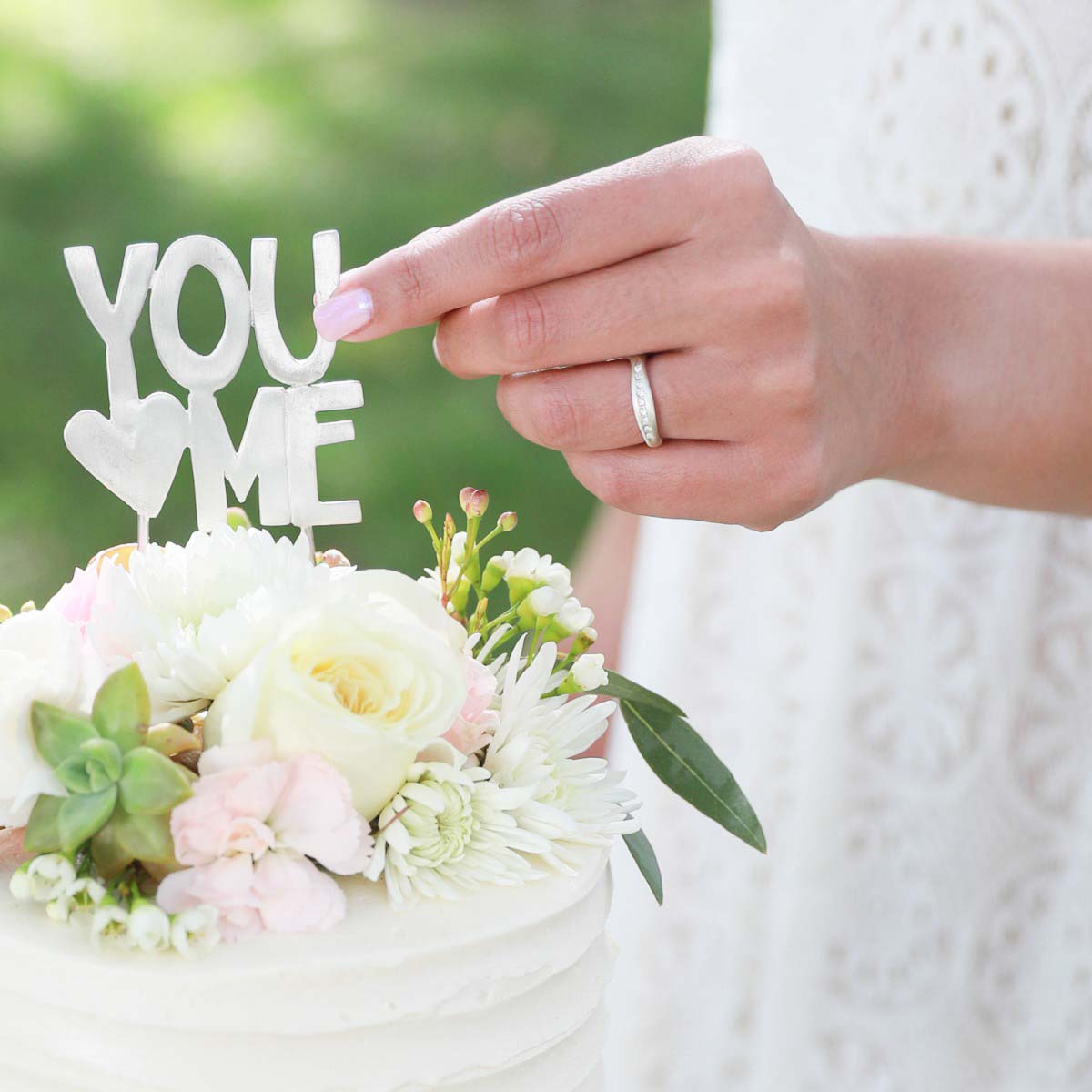 Girl wearing Passage ring handcrafted in sterling silver and display of 1.5mm cubic zirconias for her wedding