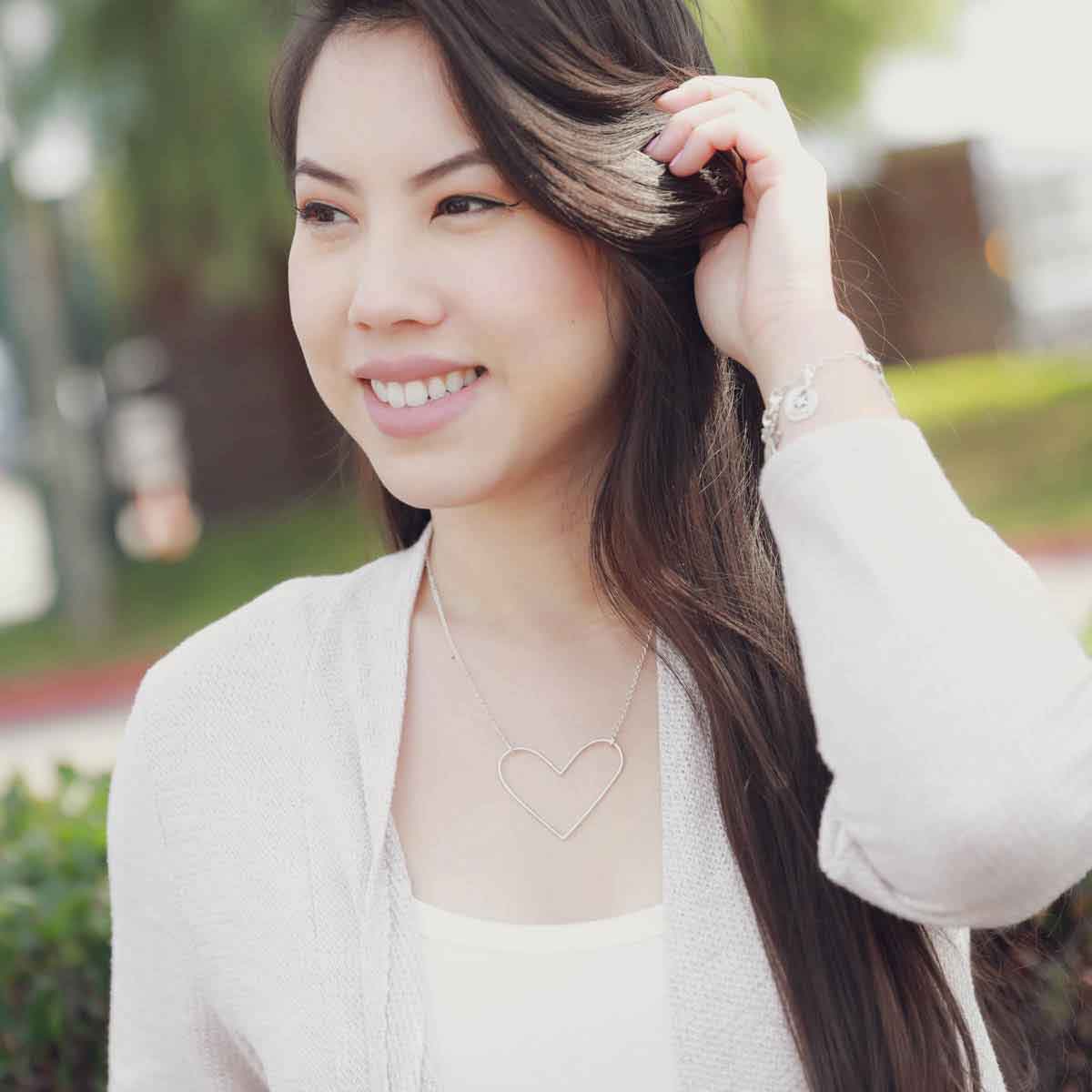 girl wearing a Peaceful Heart Necklace handcrafted in sterling silver