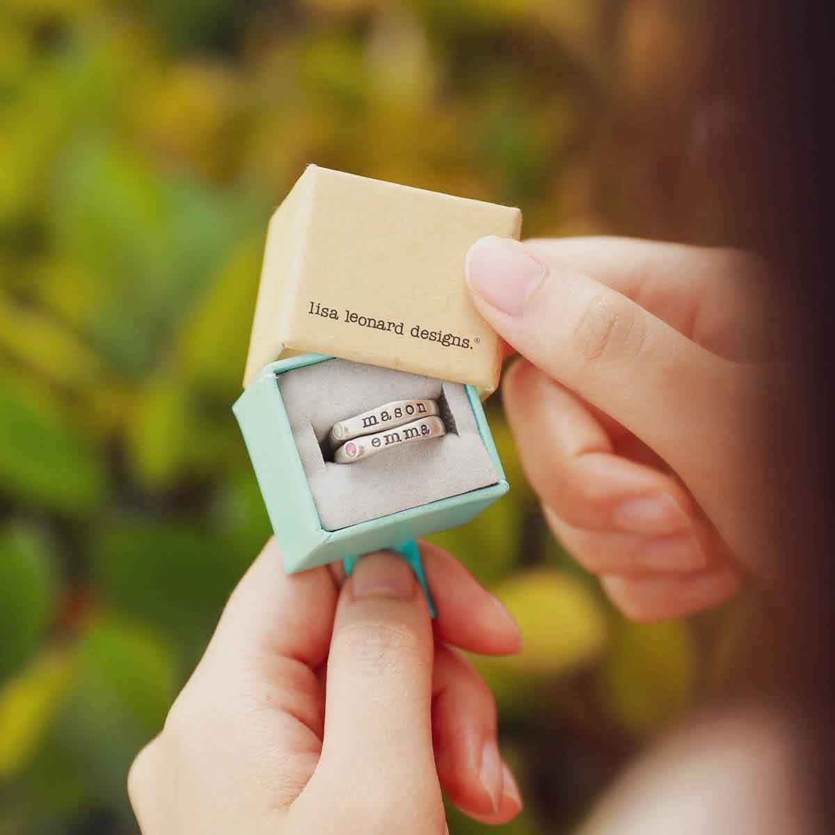 Girl holding her Personalized passage ring handcrafted in sterling silver with her choice of birthstone