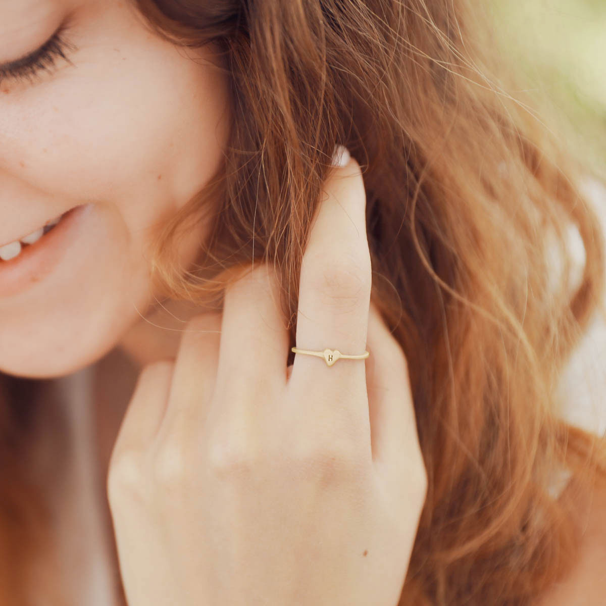 girl wearing 10k yellow gold Sweet Love Initial Ring - One Heart personalized with an initial