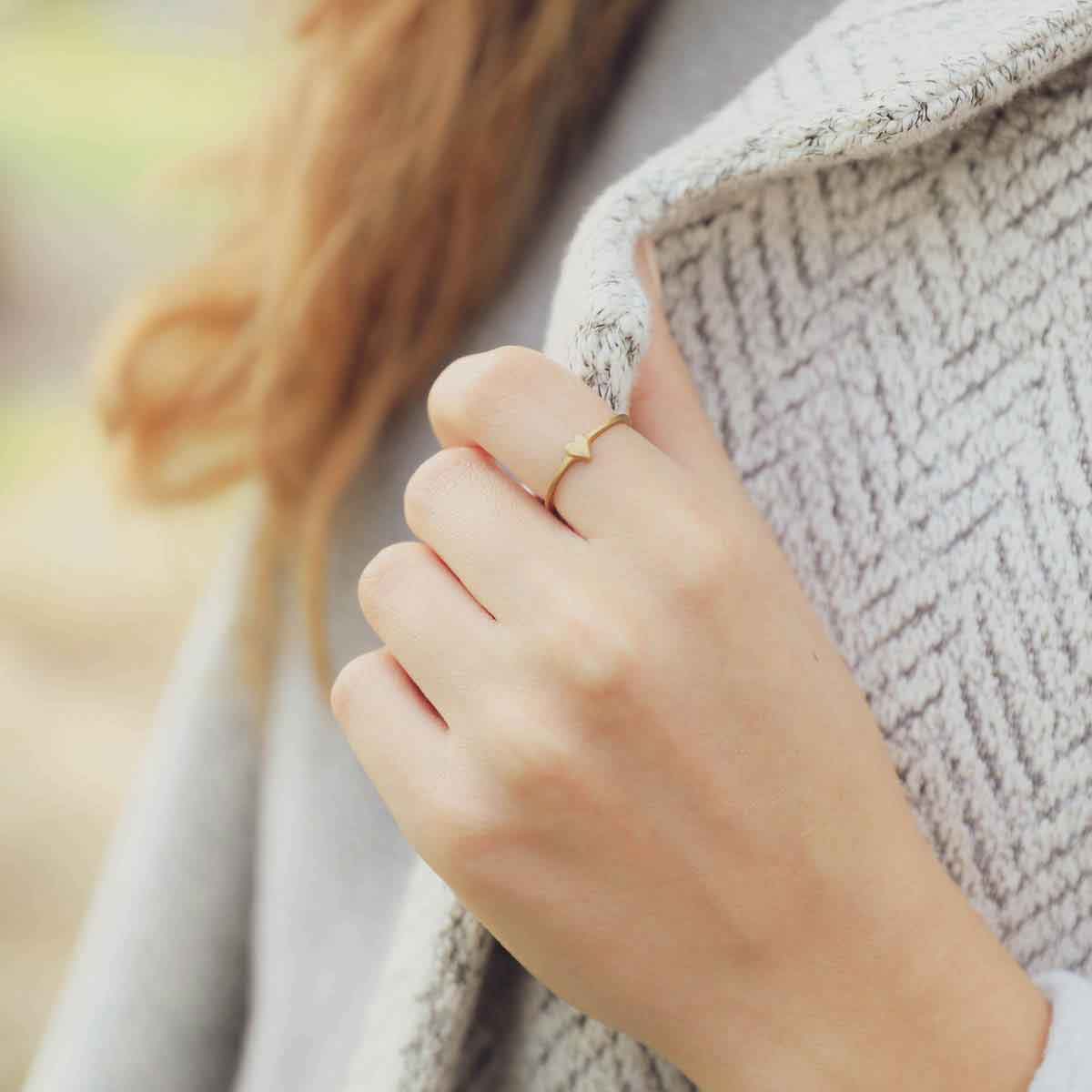 girl wearing a 10k yellow gold sweet love ring - one heart
