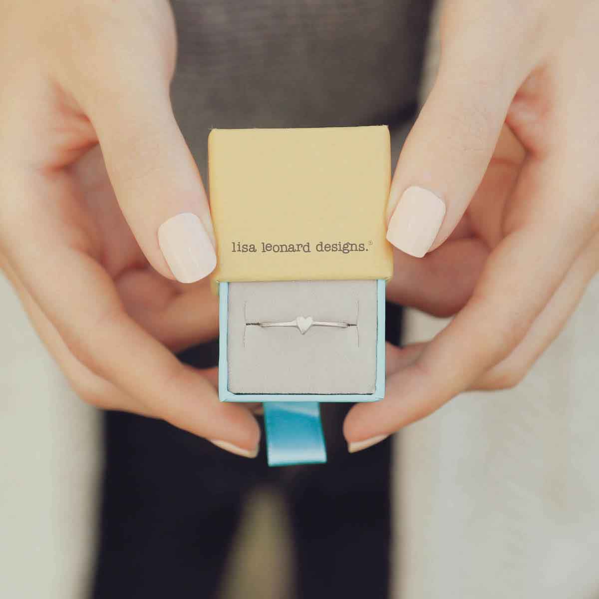 girl holding a sterling silver sweet love ring - one heart in a lisa leonard ring box
