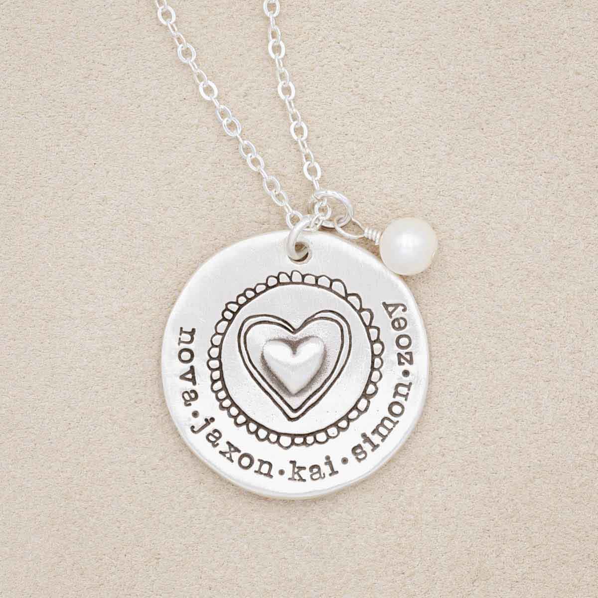 Personalized sterling silver original brave love necklace with a matte brushed finish and strung on a sliver link chain