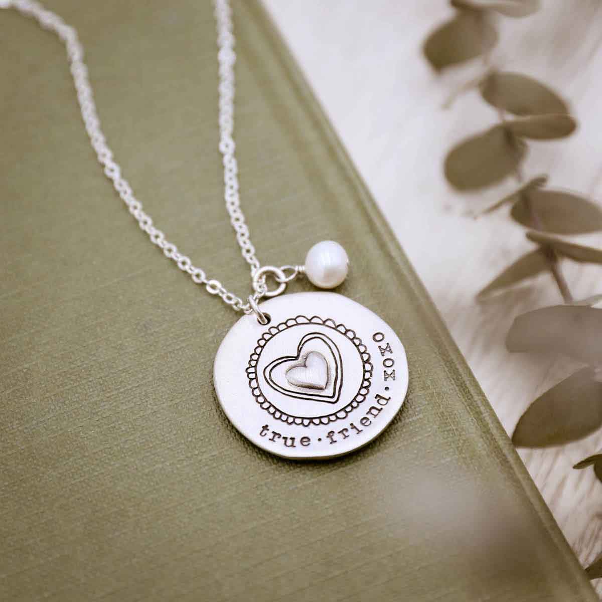 Personalized sterling silver original brave love necklace with a matte brushed finish and strung on a sliver link chain