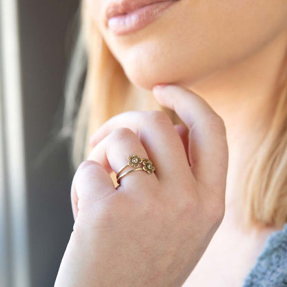 Girl wearing Birthstone bloom ring  handcrafted in 14k yellow gold with an antiqued/satin finish set with a 2mm birthstone 