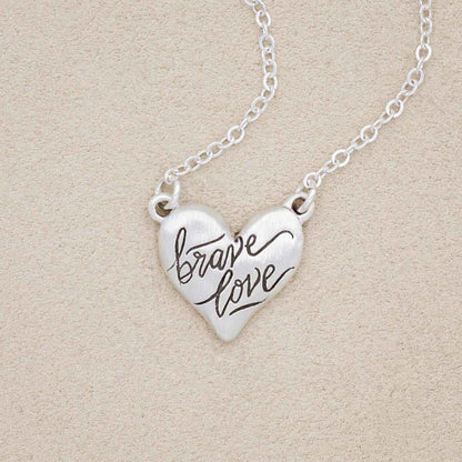 Brave Love emblem necklace handcrafted in sterling silver with brave love message engraved