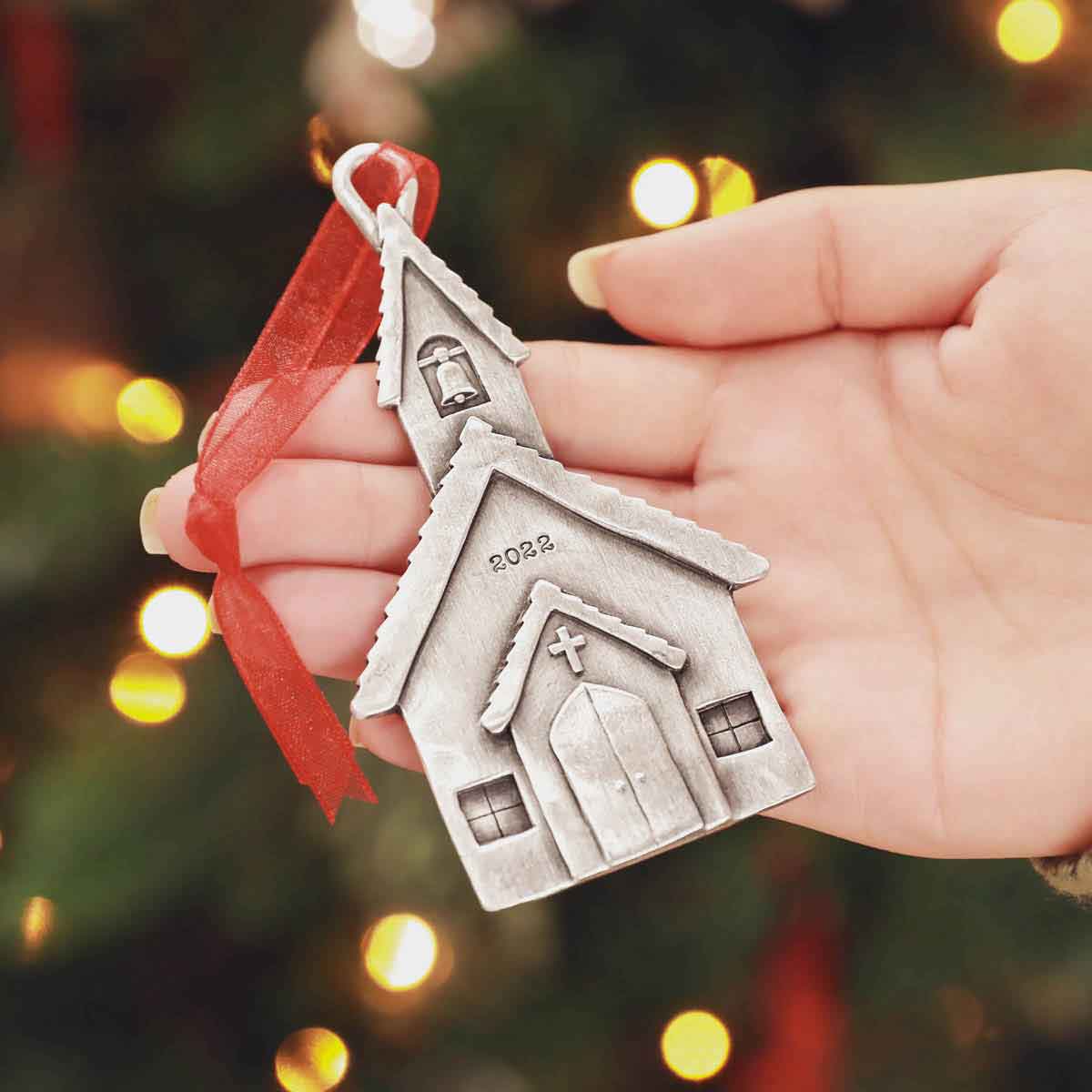 hand holding a Church Bells Ornament