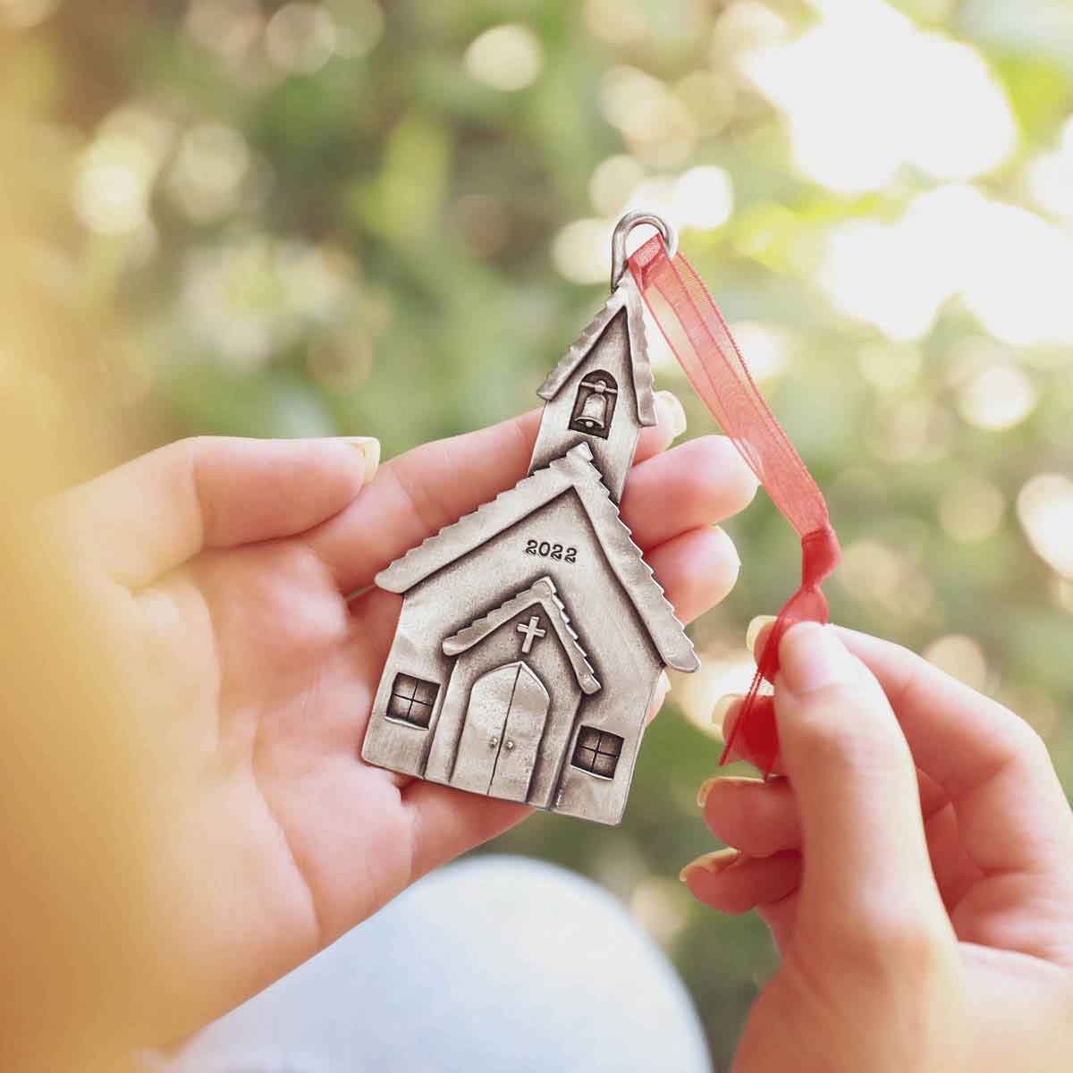 hand holding a Church Bells Ornament
