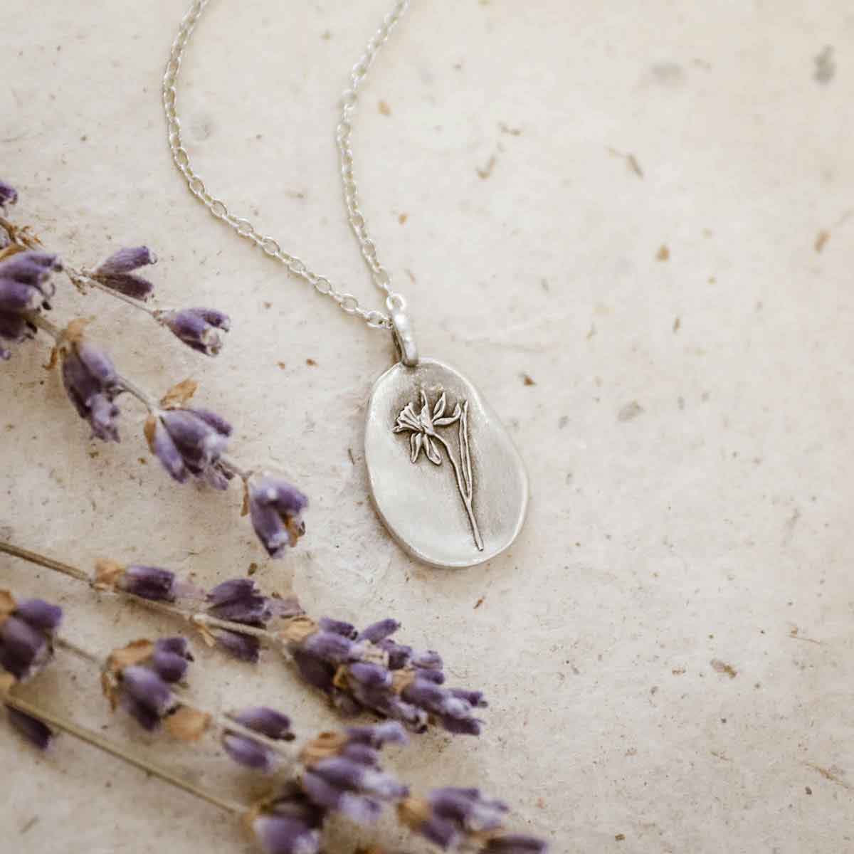 girl wearing a pewter December birth flower necklace with an 18" link chain