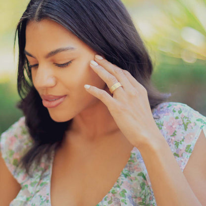Girl wearing her Faith Hope and Love ring hand-molded in 14k yellow gold set with a 3mm birthstone or diamond and two 2mm stones on the sides