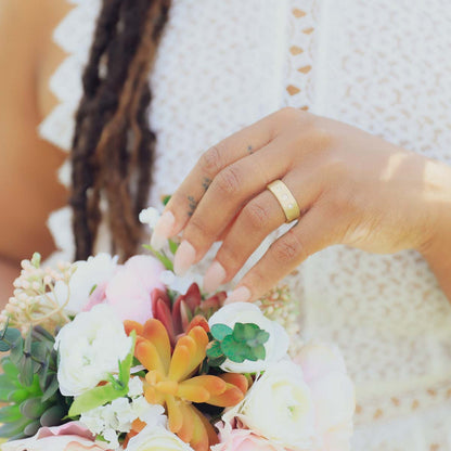 Girl wearing her Faith Hope and Love ring hand-molded in 14k yellow gold set with a 3mm birthstone or diamond and two 2mm stones on the sides 