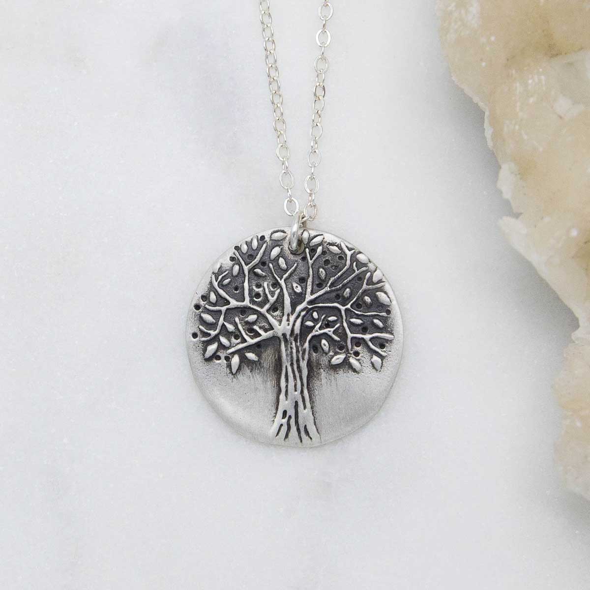 Family tree necklace handcrafted in sterling silver with a matte brushed finish and personalized with a quote or family name