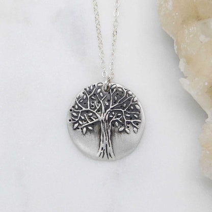 Family tree necklace handcrafted in sterling silver with a matte brushed finish and personalized with a quote or family name