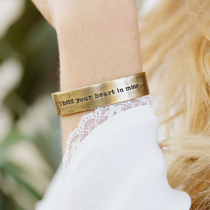 Girl wearing Handcrafted artisan bronze-plated pewter I hold your heart cuff bracelet