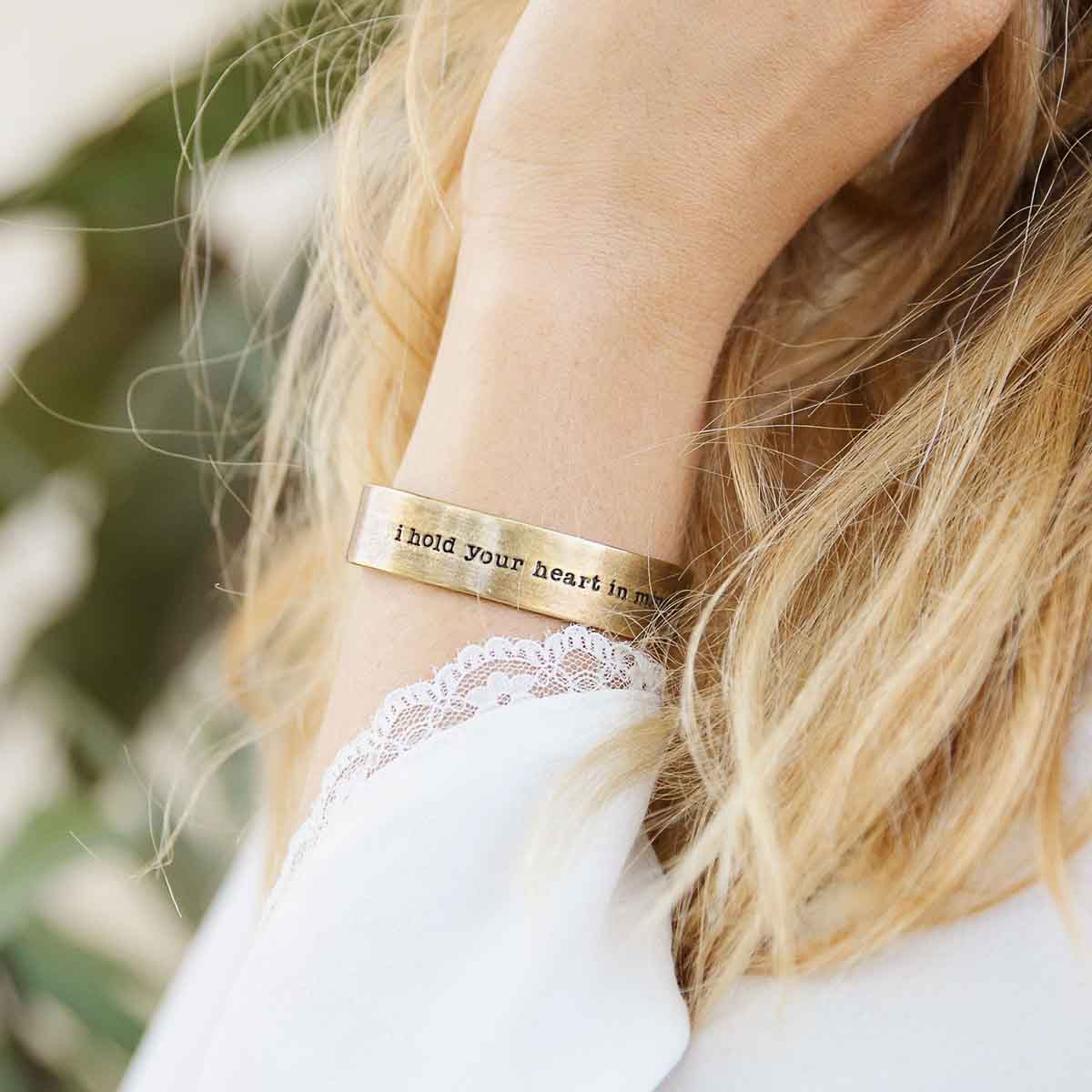 Girl wearing Handcrafted artisan bronze-plated pewter I hold your heart cuff bracelet