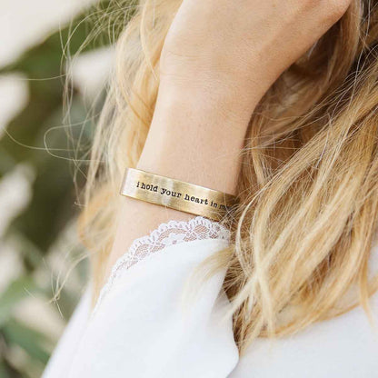 Girl wearing Handcrafted artisan bronze-plated pewter I hold your heart cuff bracelet