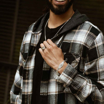 man wearing a sterling silver Identity Bracelet with a hand stamped personalized metal plate
