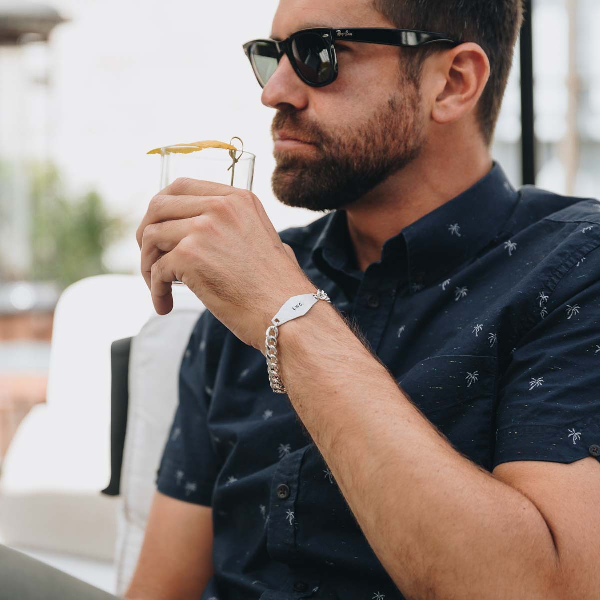 man wearing a sterling silver Identity Bracelet with a hand stamped personalized metal plate