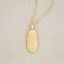 gold plated July birth flower necklace with an 18" gold filled link chain, on beige background