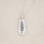 sterling silver July birth flower necklace, on beige background